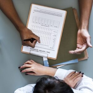 Aerial view of doctor writing patient daily report checklist