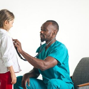 The healthcare and medical concept - african male doctor with stethoscope listening to child chest in hospital. The doctor, health, medicine, patient, pediatrician, illness concepts