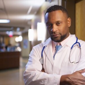 A portrait of an African-American doctor in a hospital under the lights with a blurry background