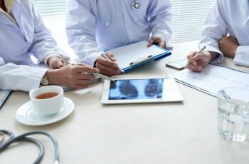 Doctors discussing chest x-ray on tablet computer